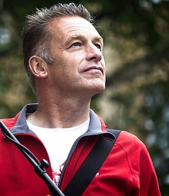 Chris Packham standing outdoors in a dark jacket.