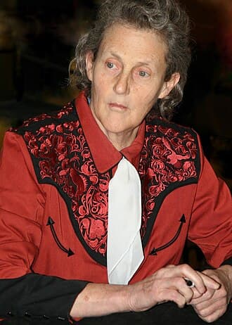 Temple Grandin speaking and smiling outdoors.